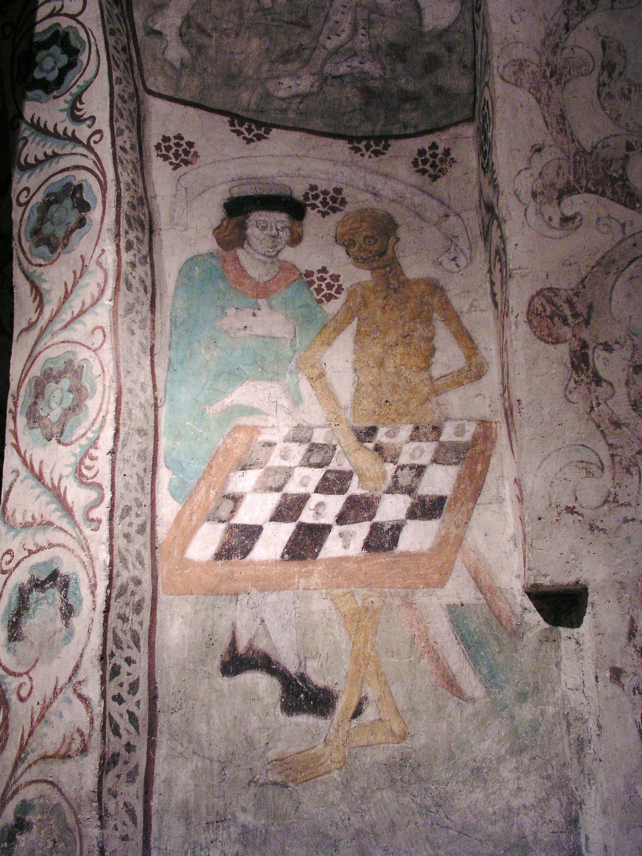 albertus pictor’s painting in täby church: death, a near-skeleton, at a chessboard beside a man in a hat and robe, one hand on a piece