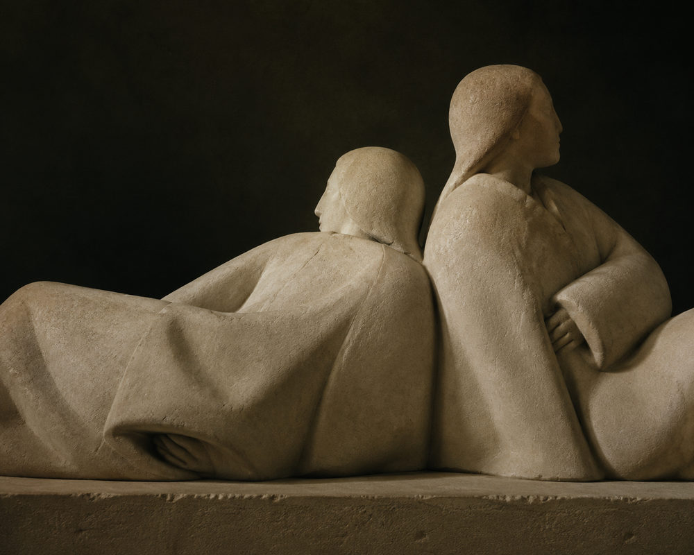 stone repose: reclining robed figures, dark moody photography, warm sandstone beige